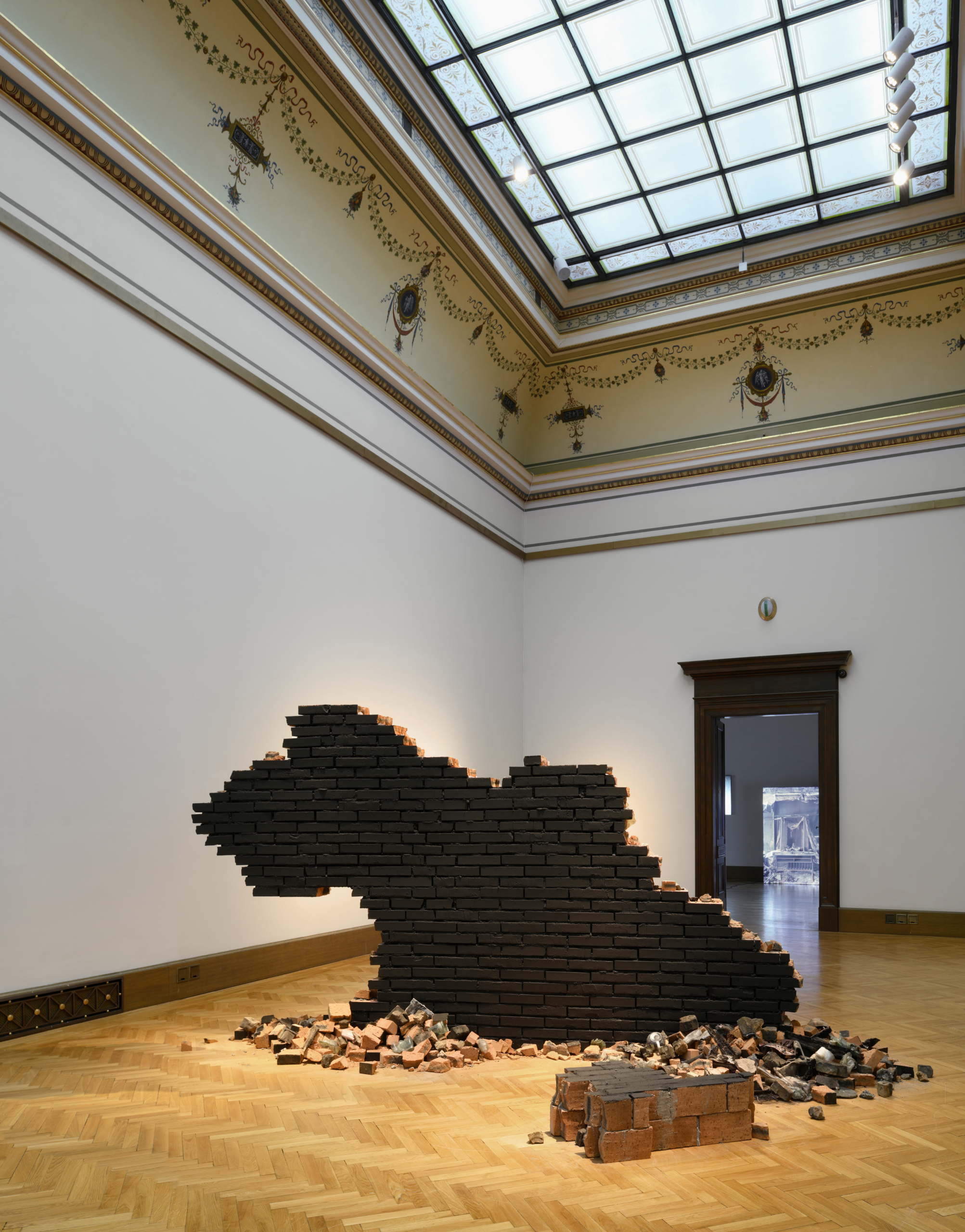 Zhanna Kadyrova. Home (Untitled) (2014–2023). 2023. Metal, brick, wallpaper, coal