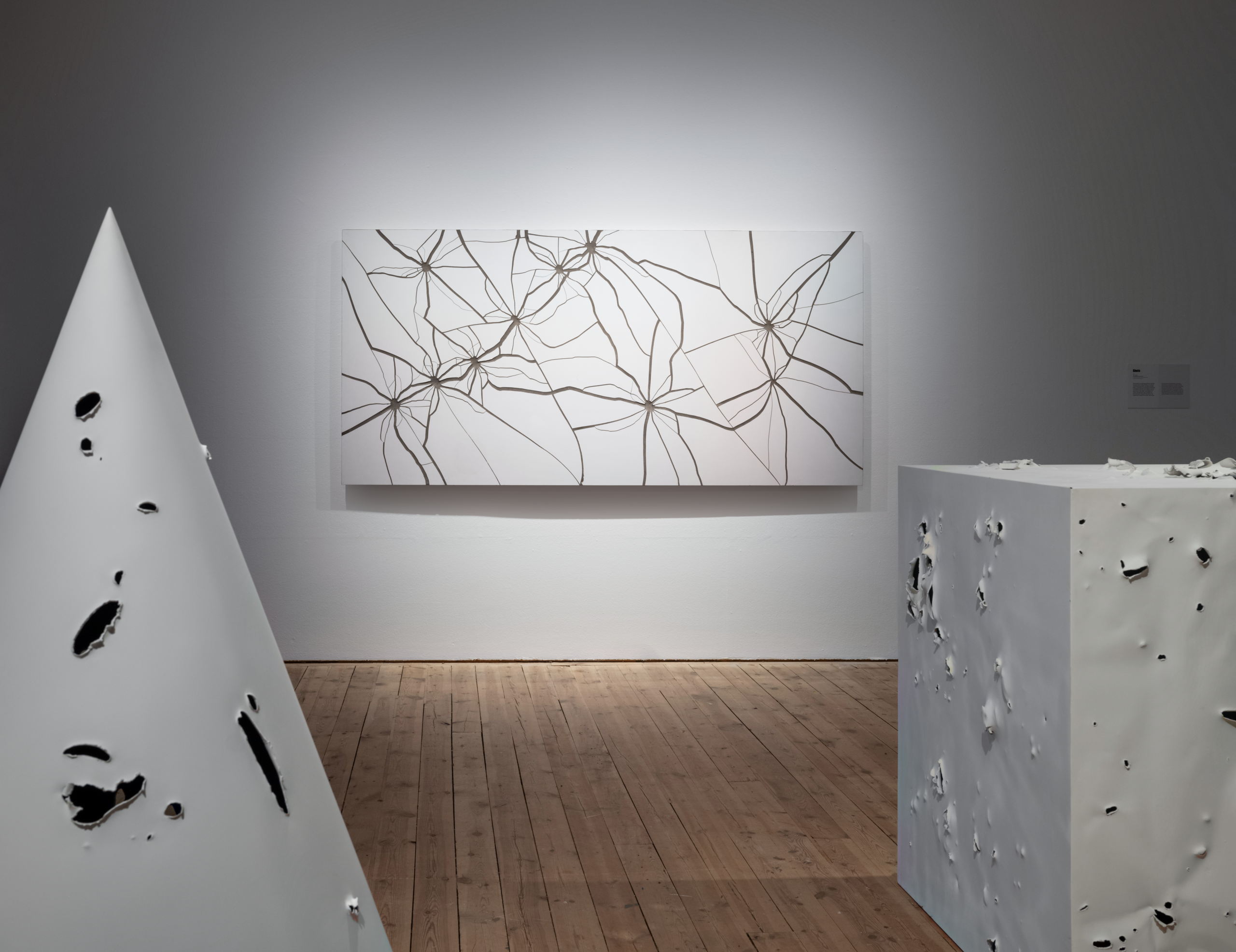 Zhanna Kadyrova. Shots, 2023 (2009 — ongoing), porcelain stoneware, cement, wood, and Harmless War, 2022, found bullet-ridden metal sheets, Border Memory, exhibition view, Uppsala Art Museum, Uppsala (Sweden), 2024